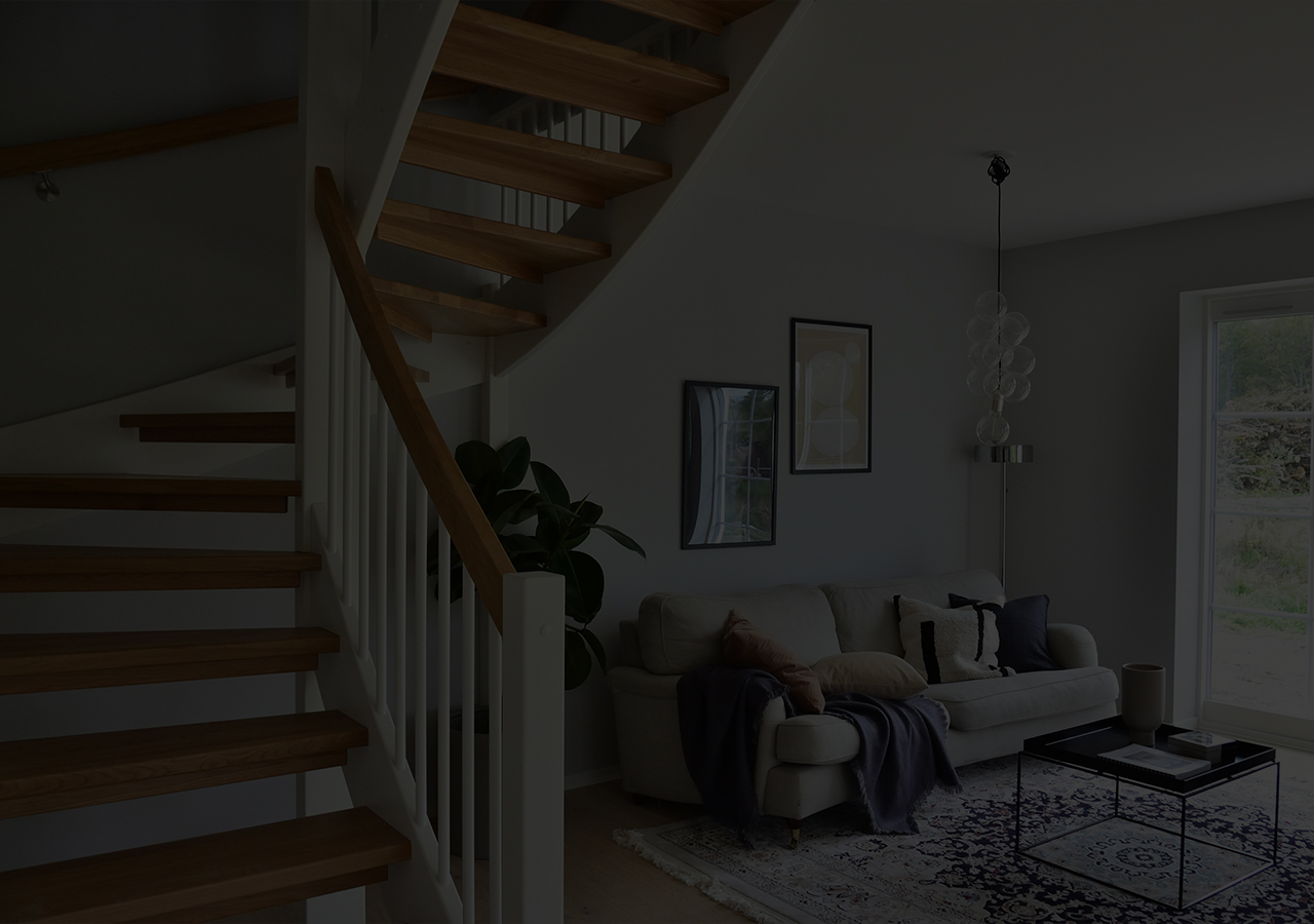 A contemporary timber staircase in a cozy and light living room.