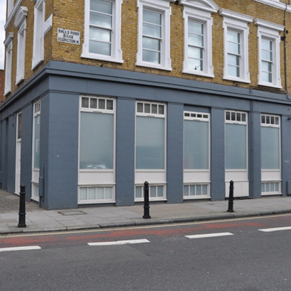 Windows, doors, and shopfront on a building on Balls Pond Road, N1, Islington, London.