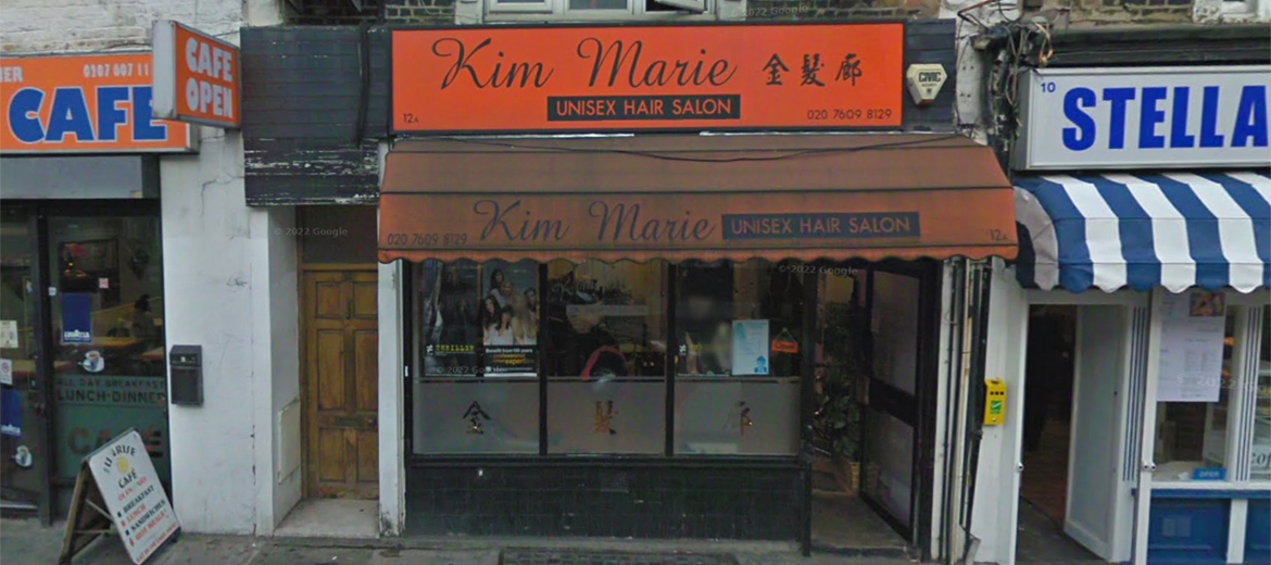 An old before-photo of windows, doors and shopfront on a an orange-themed retail shop on Brecknock Road, N7, Islington, London.