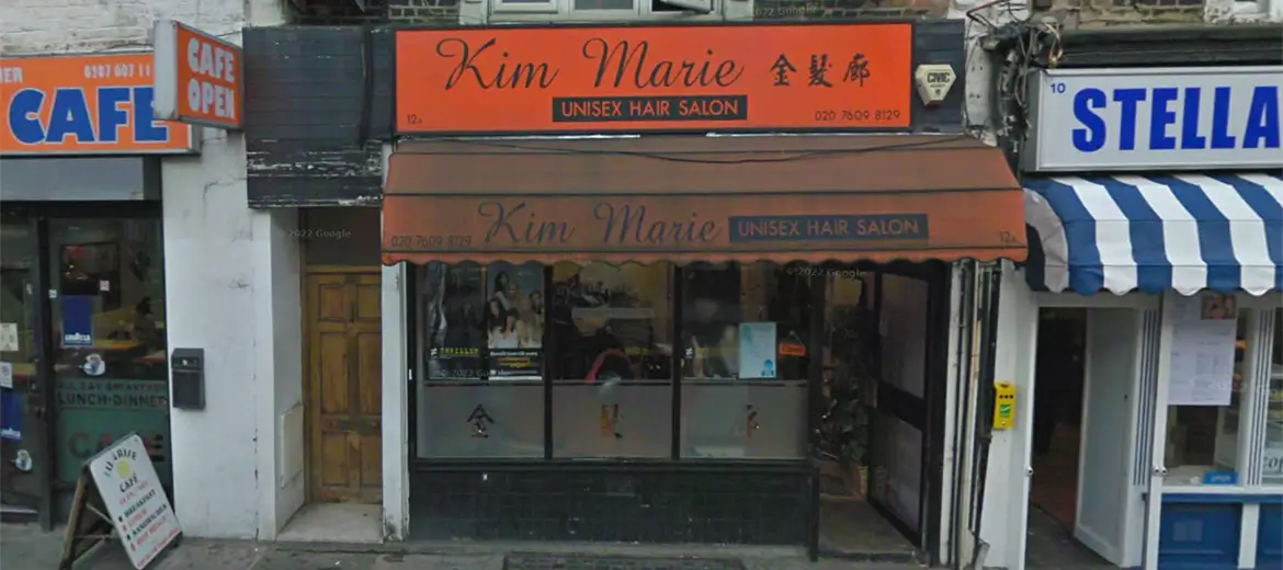 An old before-photo of windows, doors and shopfront on a an orange-themed retail shop on Brecknock Road, N7, Islington, London.