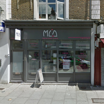 Windows, doors and shopfront on a building on Brecknock Road, N7, Islington, London.